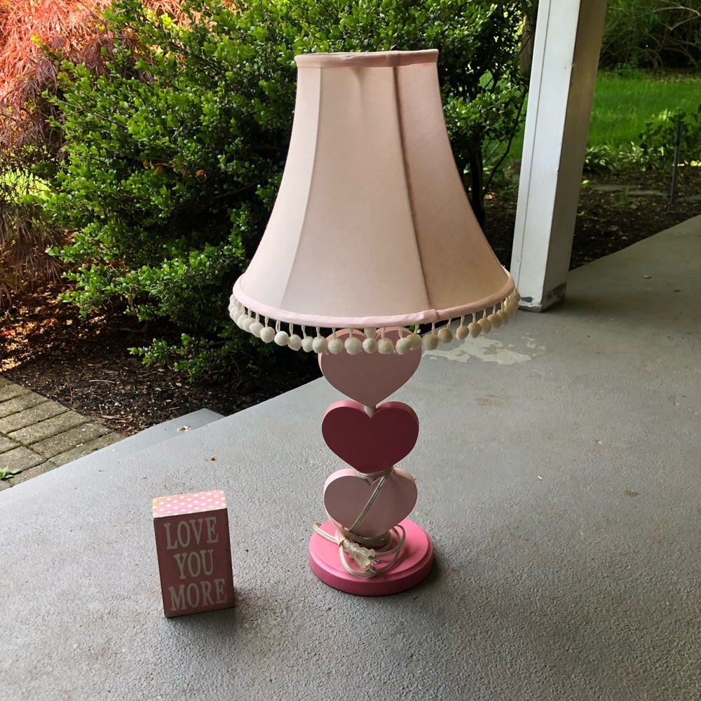 Girls room.  Lamp and wall or desk sign